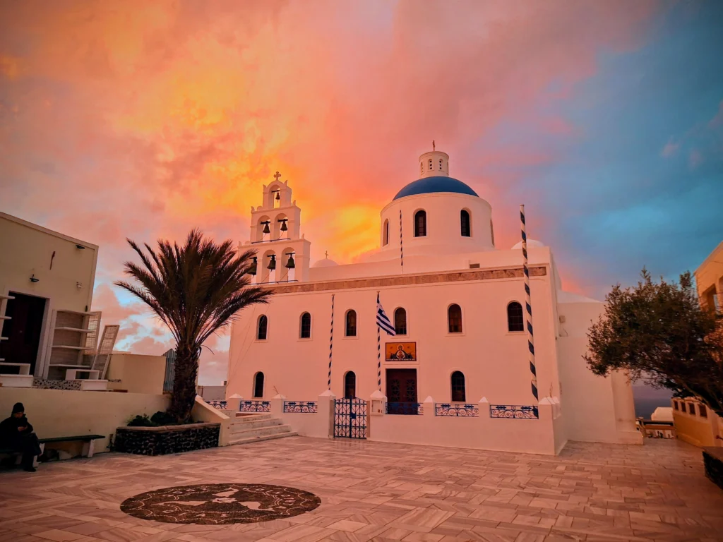 Panagia Platsiani or Virgin Mary of Akathism Hymn in Oia's main square, a stunning post-sunset cloud display in January