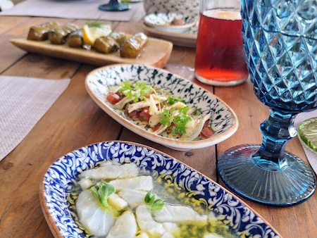 Real homecooked meal at Kissiras Santorini Microgreens, complete with house-style wine, dolmades, anchovy and marinated white fish