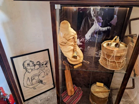 Symposion Cultural Center in Megalochori Santorini inside a restored cave winery with traditional musical instruments.