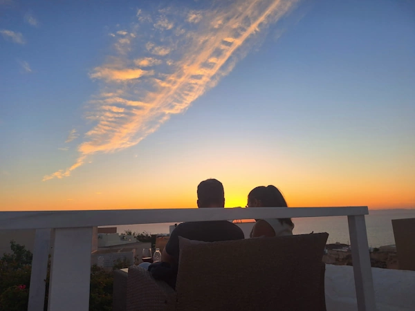 Guests enjoying their private romantic sunset moment away from the crowds in the garden of Domus K 1885, a restored captain’s house in the heart of Oia, Santorini
