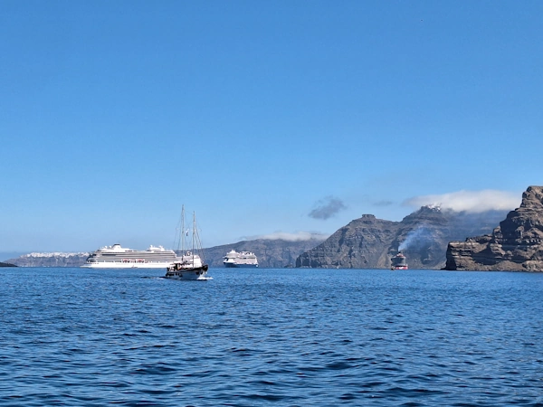 Santorini, view from Athinios, the new harbor, with the anedosa sea fog over Imerovigli village - the view you get if your shore excursion starts in Athinios